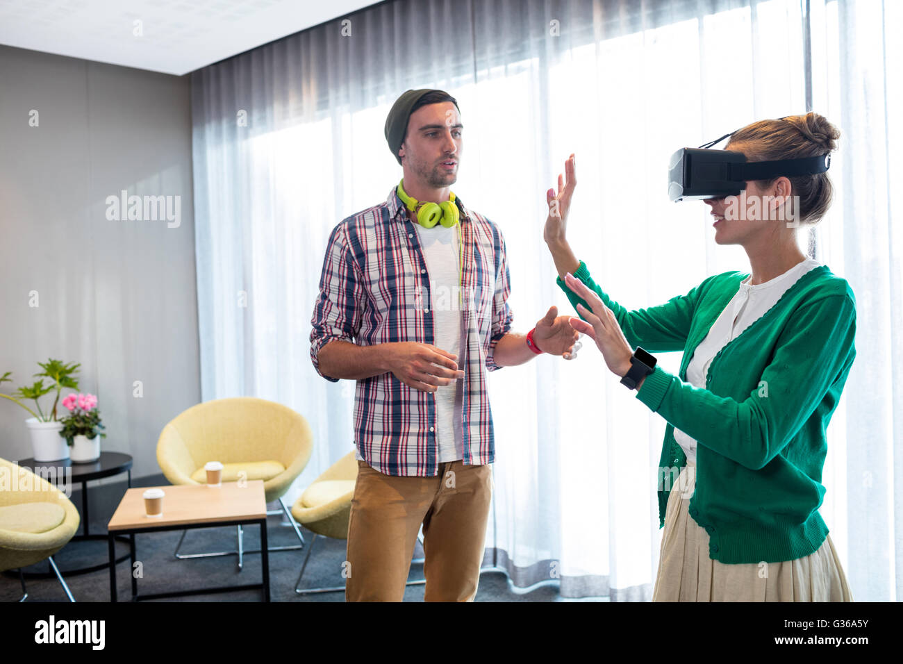 Coworker using an oculus Stock Photo - Alamy
