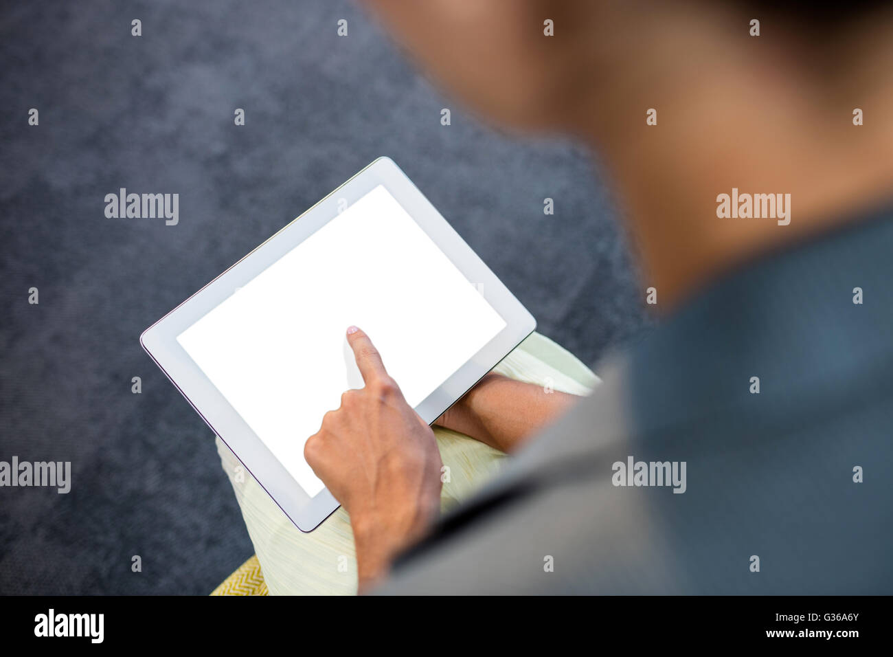 Focus on background of hand using a tablet Stock Photo