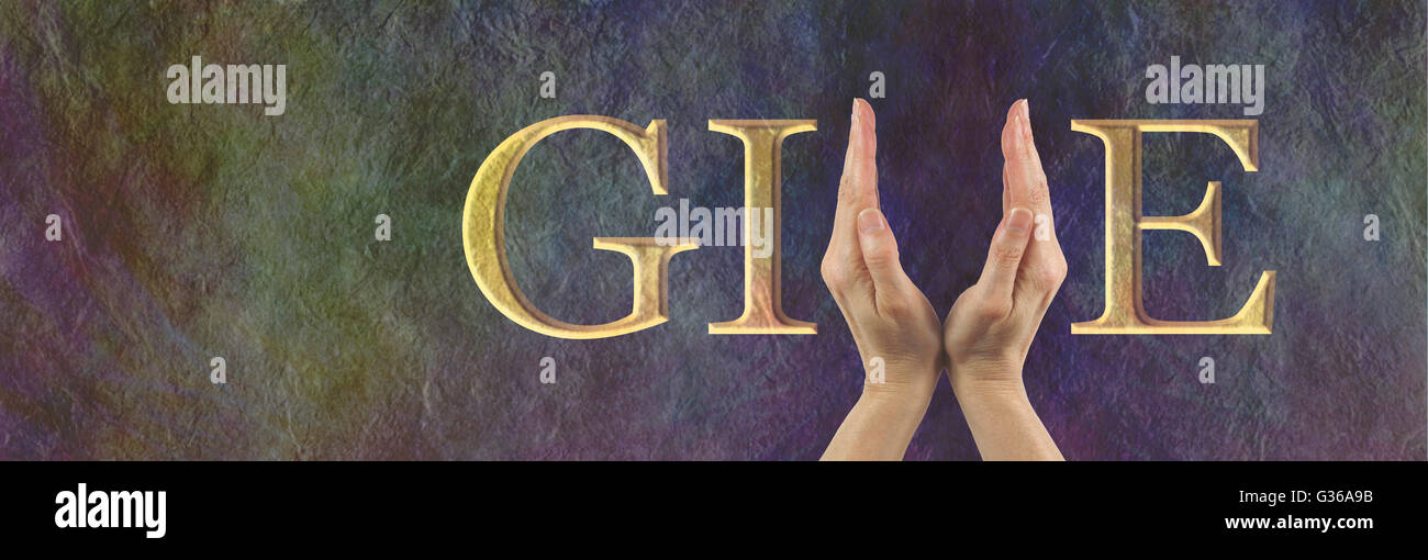 Female hands making the V of GIVE on a wide rustic stone effect banner with copy space on left side Stock Photo