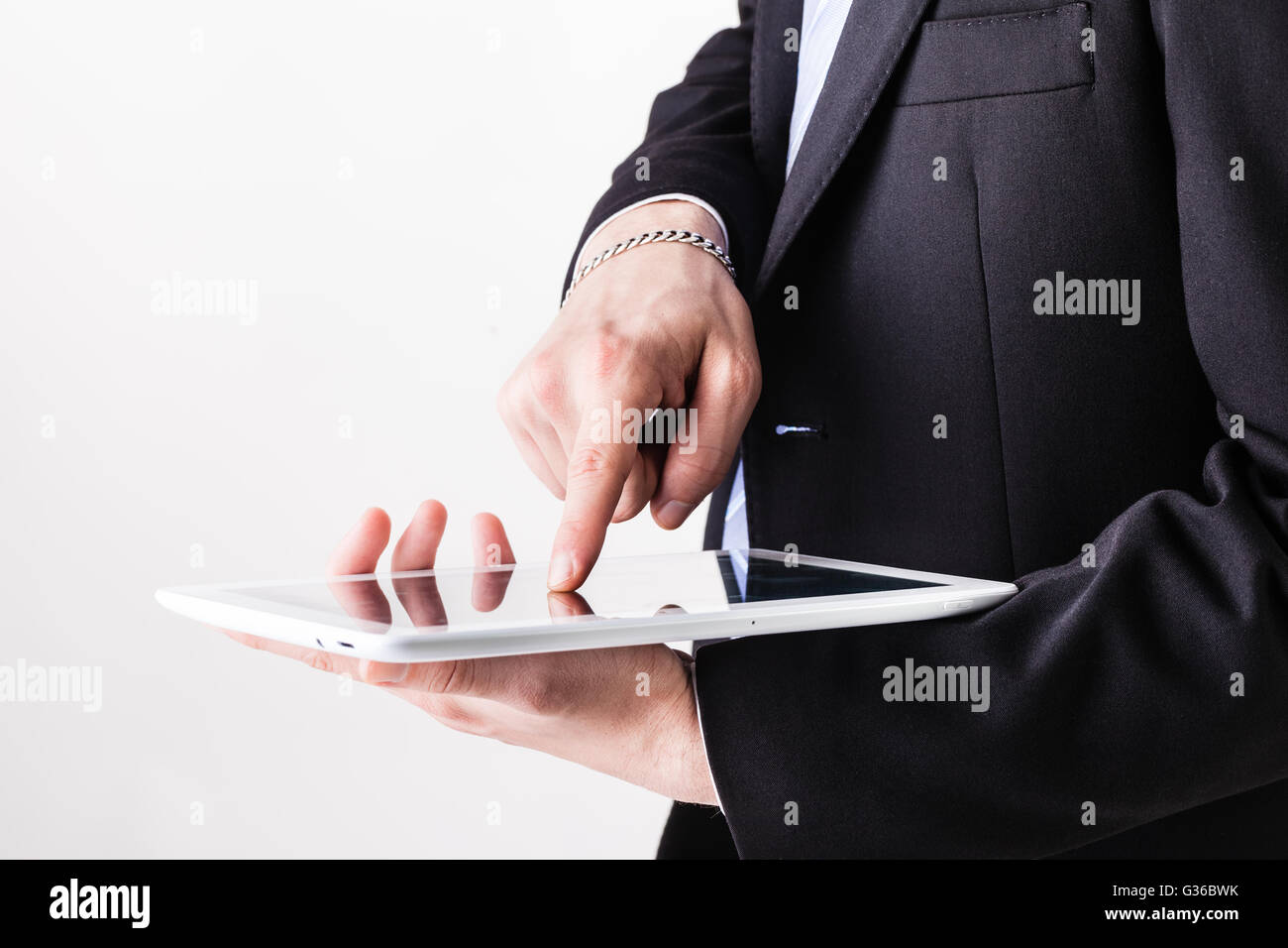 a businessman using the touchscreen of a tablet with his hands Stock ...