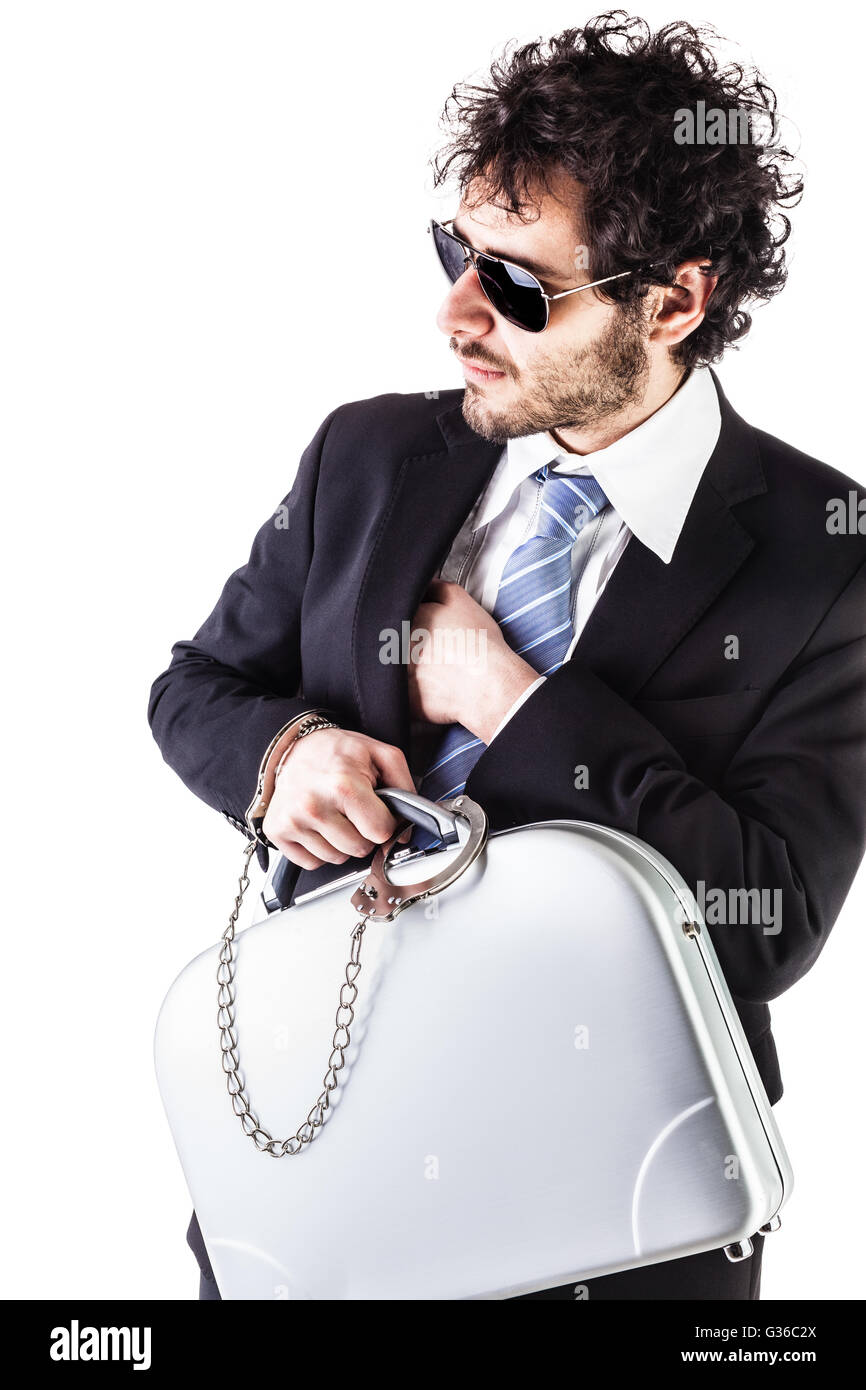 Businessman wearing a suit with a secure suitcase attached with