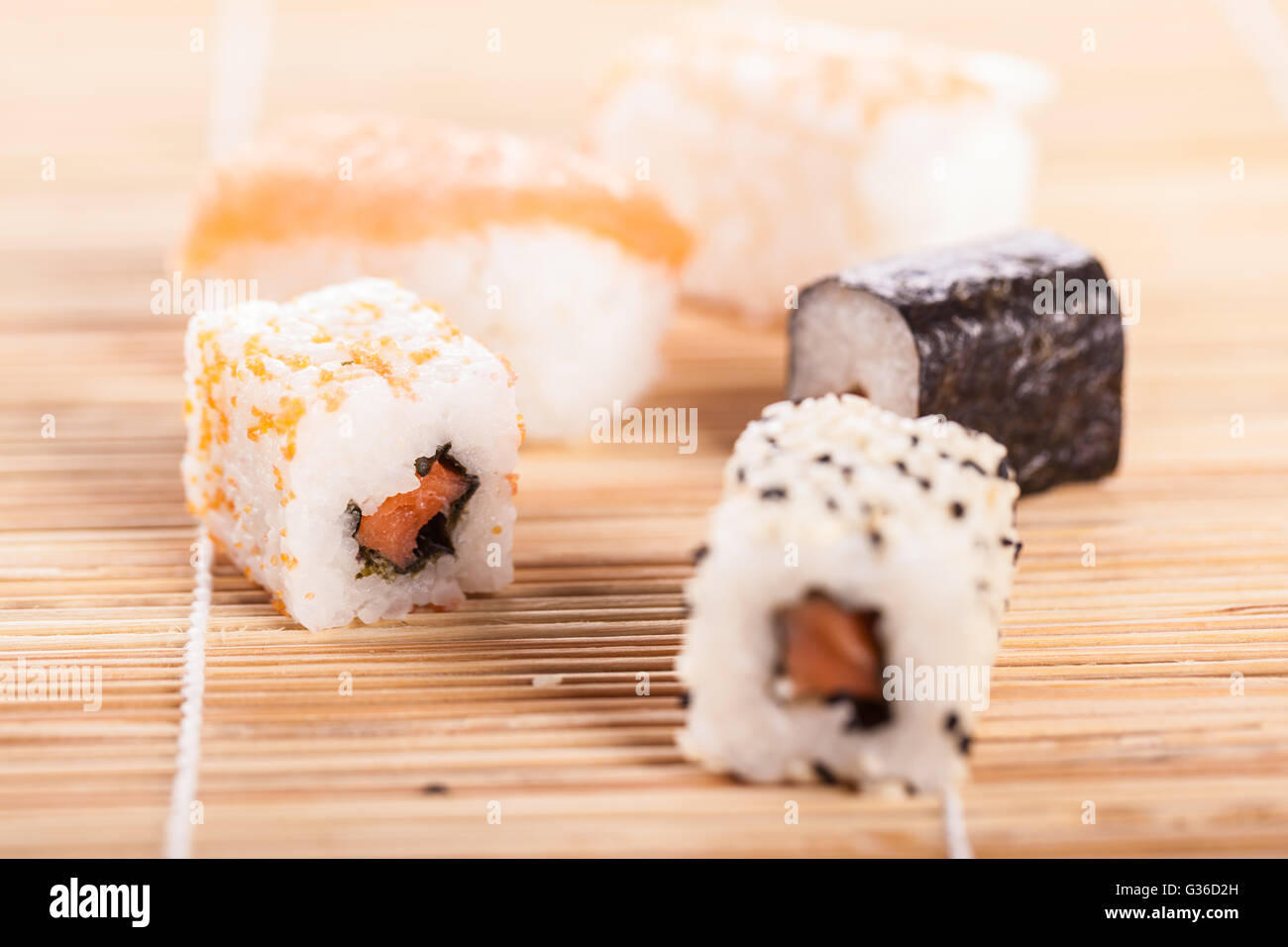 An Assortment Of Different Sushi Pieces On A Wooden Bamboo Sushi