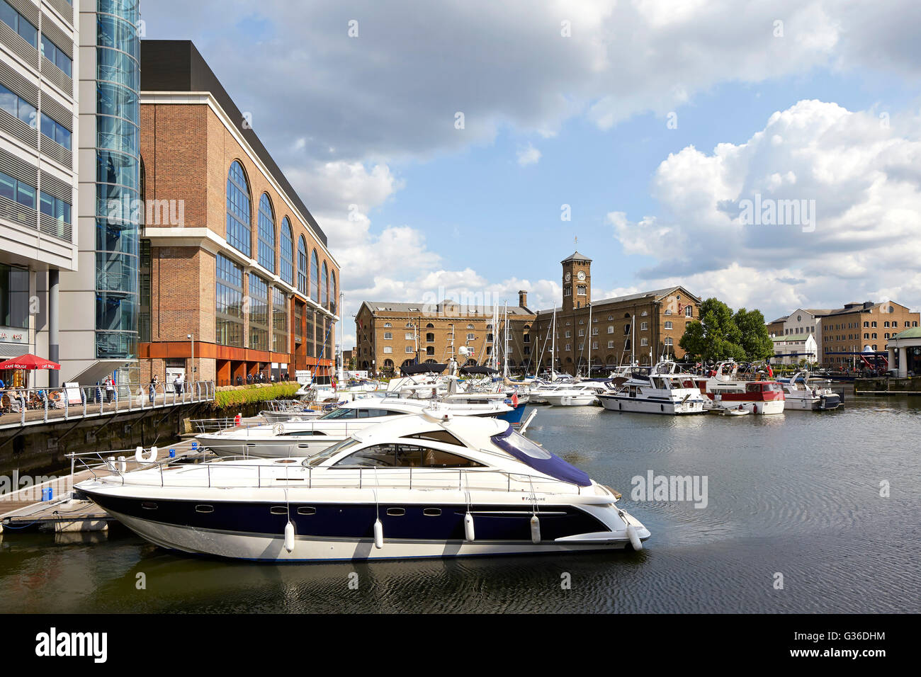 Contextual view with yachts. Commodity Quay, London, United Kingdom. Architect: BuckleyGrayYeoman, 2014. Stock Photo