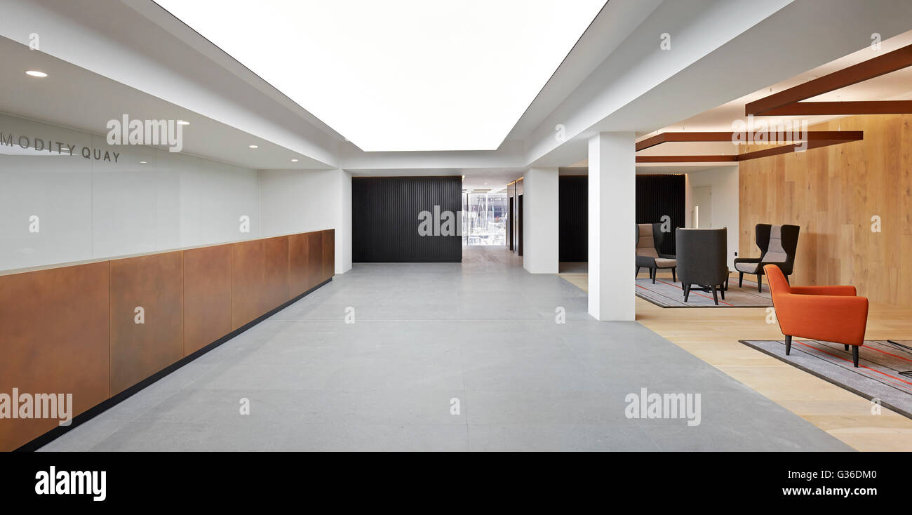 Reception with desk and lounge. Commodity Quay, London, United Kingdom. Architect: BuckleyGrayYeoman, 2014. Stock Photo