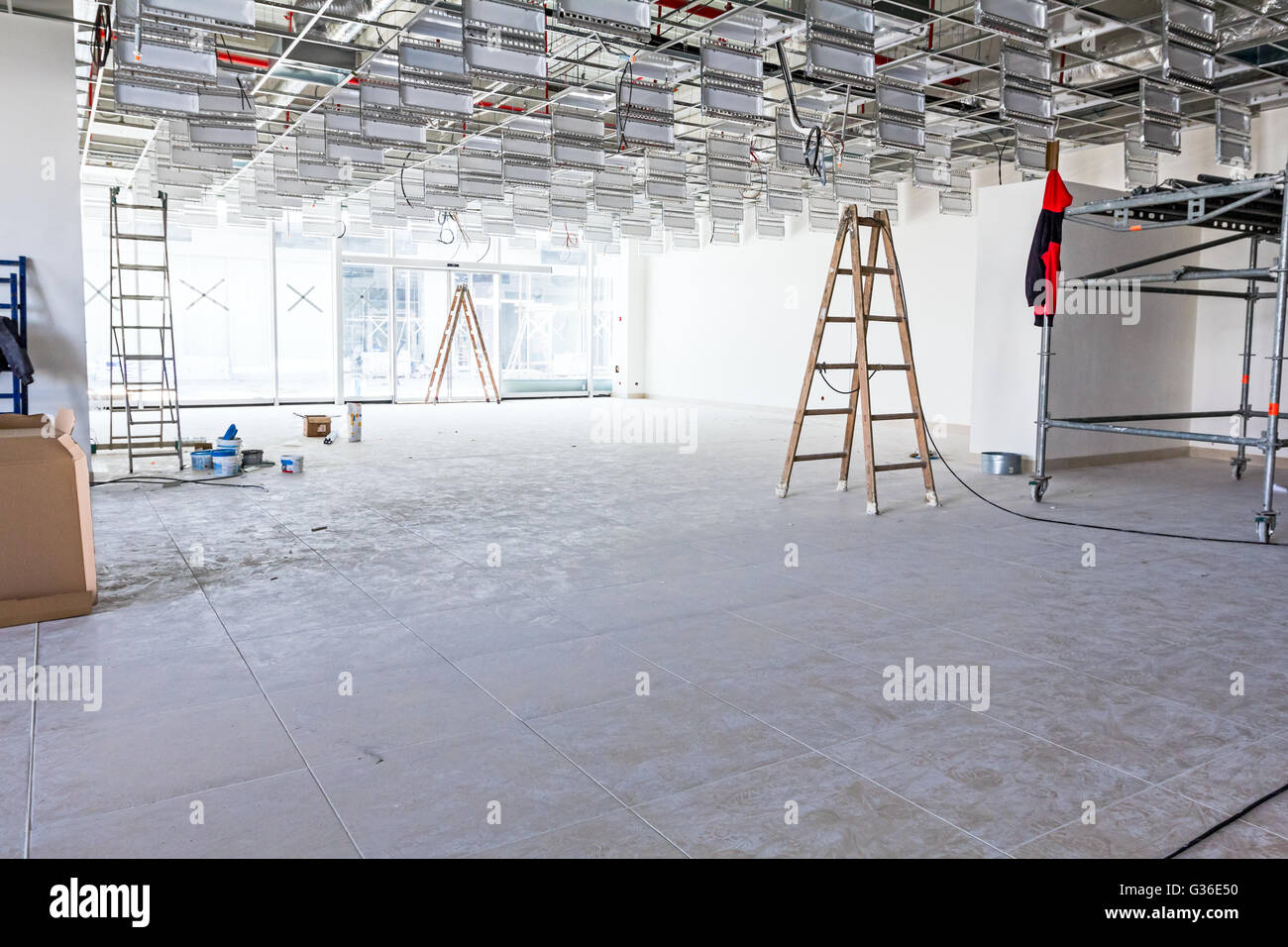 Workers are used wooden ladder to complete suspended office ceiling at