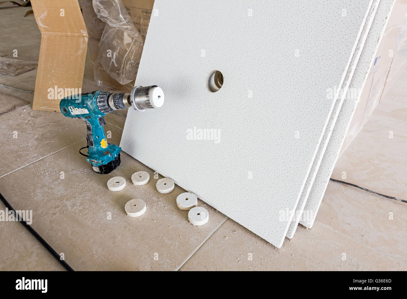 Precision drilling a hole with hole saw trough plasterboard. Stock Photo