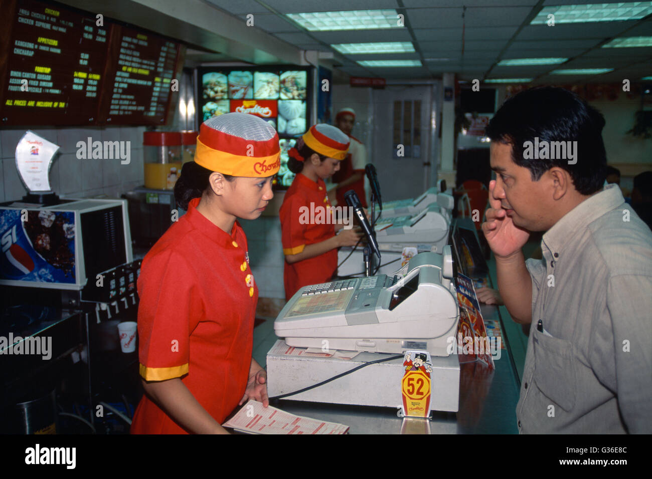 Fast Food Workers At Till In Restaurant, Manila, Philippines Stock