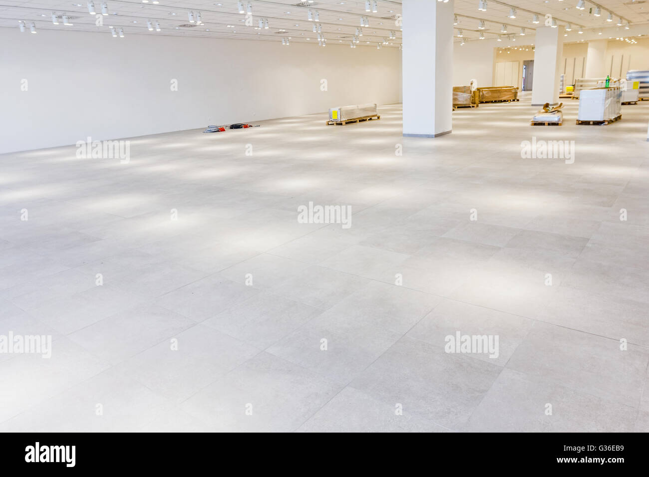 Furnishing equipment is on the floor for white room with ceiling light