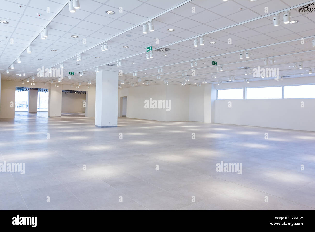 View on large showroom in a modern business centre with ceiling lamps. Stock Photo