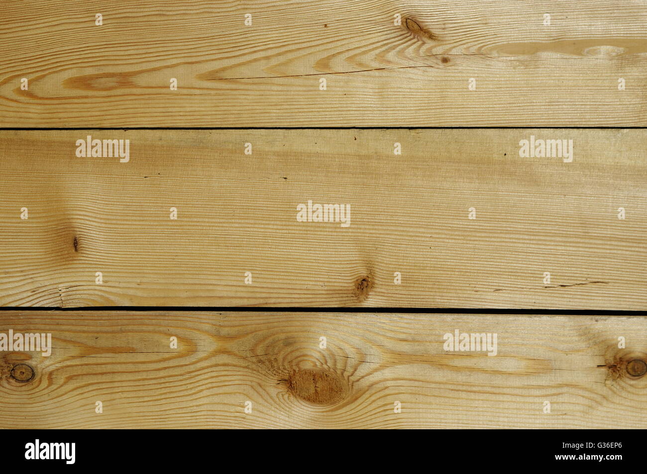 Wooden floor with spruce, planed boards with knots. Stock Photo