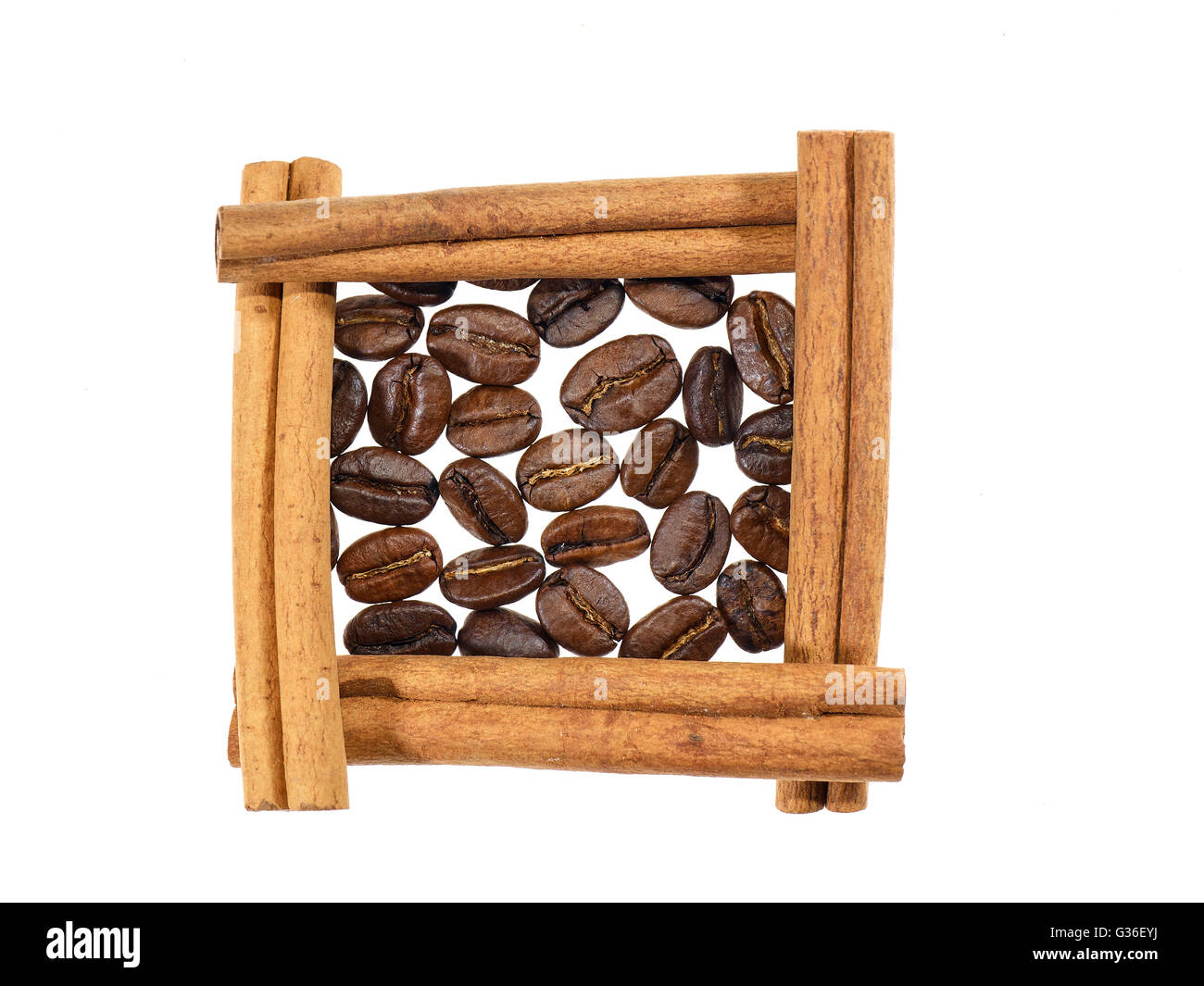 Roasted coffee beans in square of cinnamon sticks on white background Stock Photo