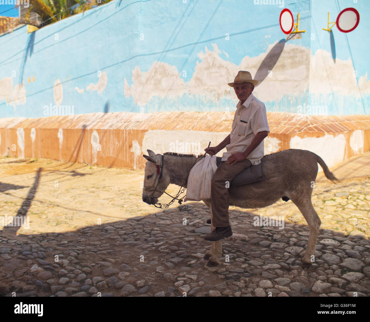 Old man on mule in center of Trinidad, Cuba Stock Photo