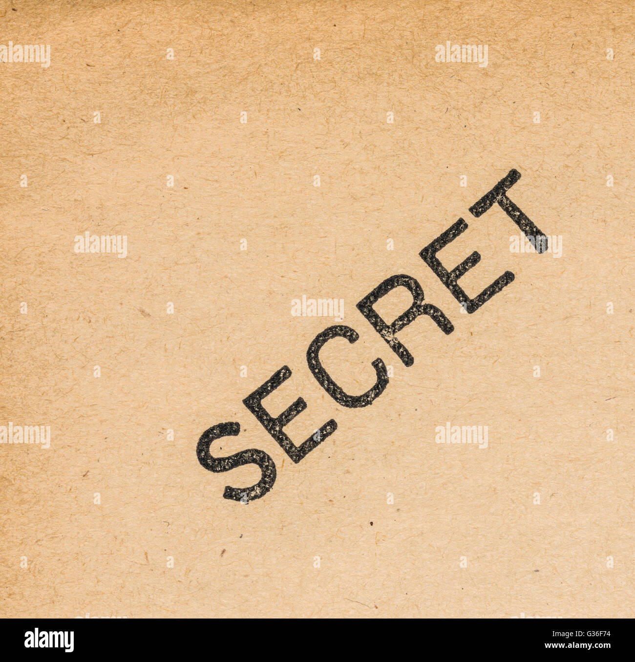 the word Secret printed on a yellowed old paper sheet Stock Photo