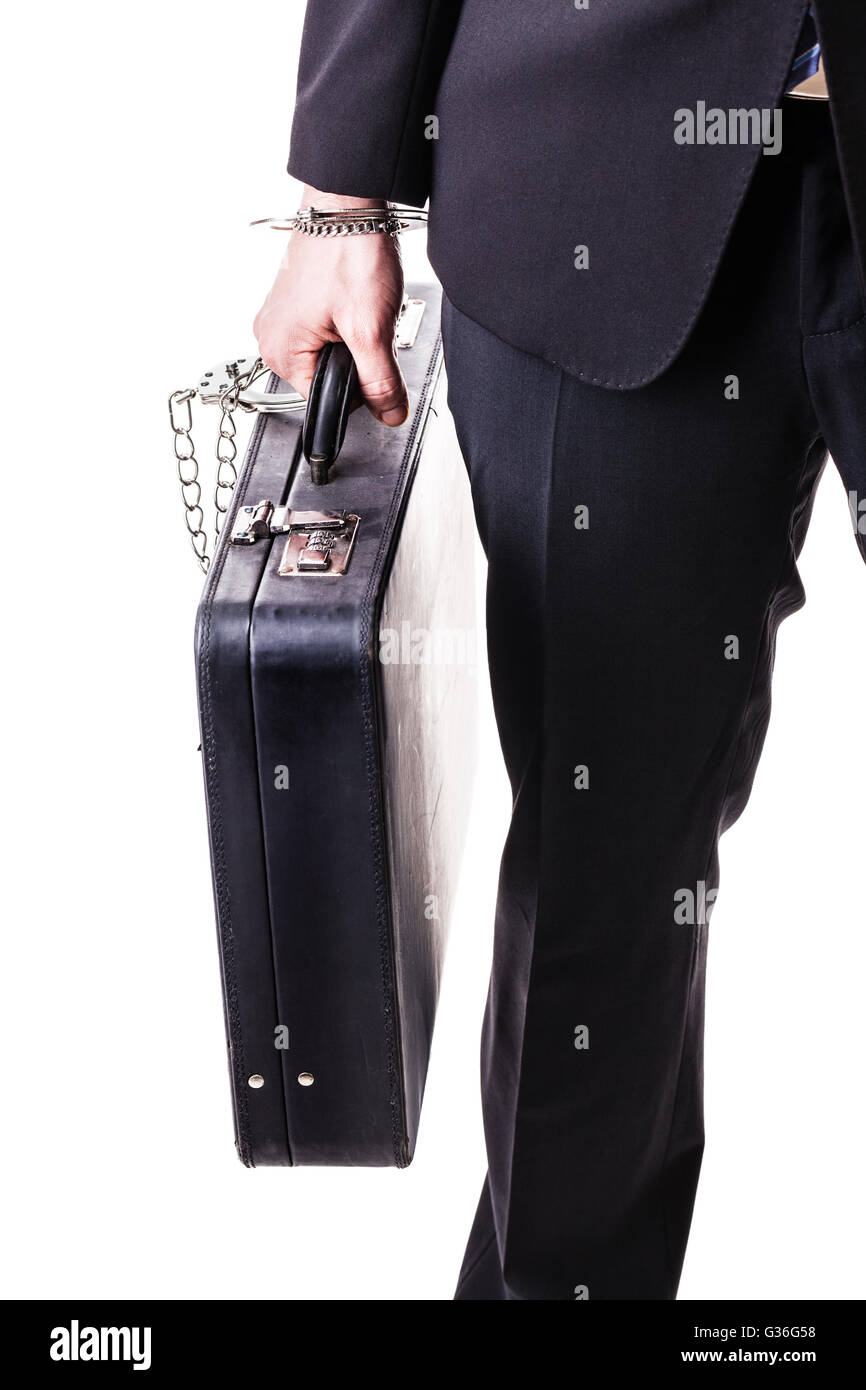 Businessman wearing a suit with a secure suitcase attached with handcuffs isolated over a white background Stock Photo