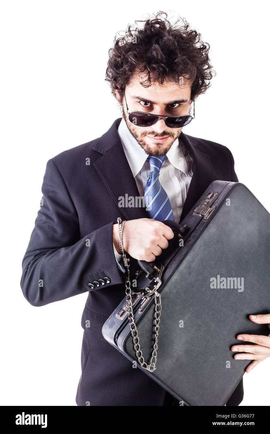 Businessman wearing a suit with a secure suitcase attached with