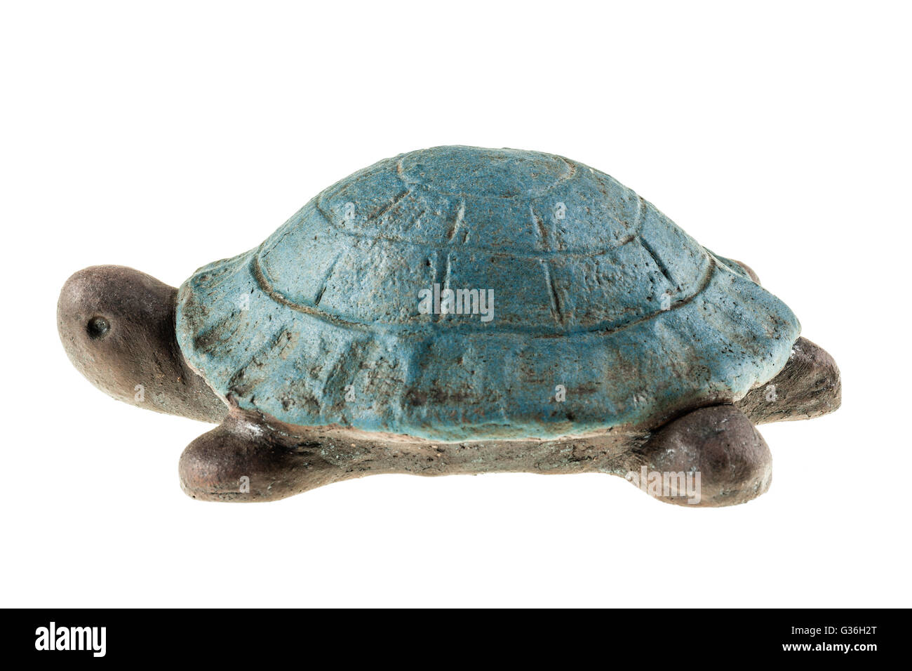a small clay turtle figurine isolated over a white background Stock Photo