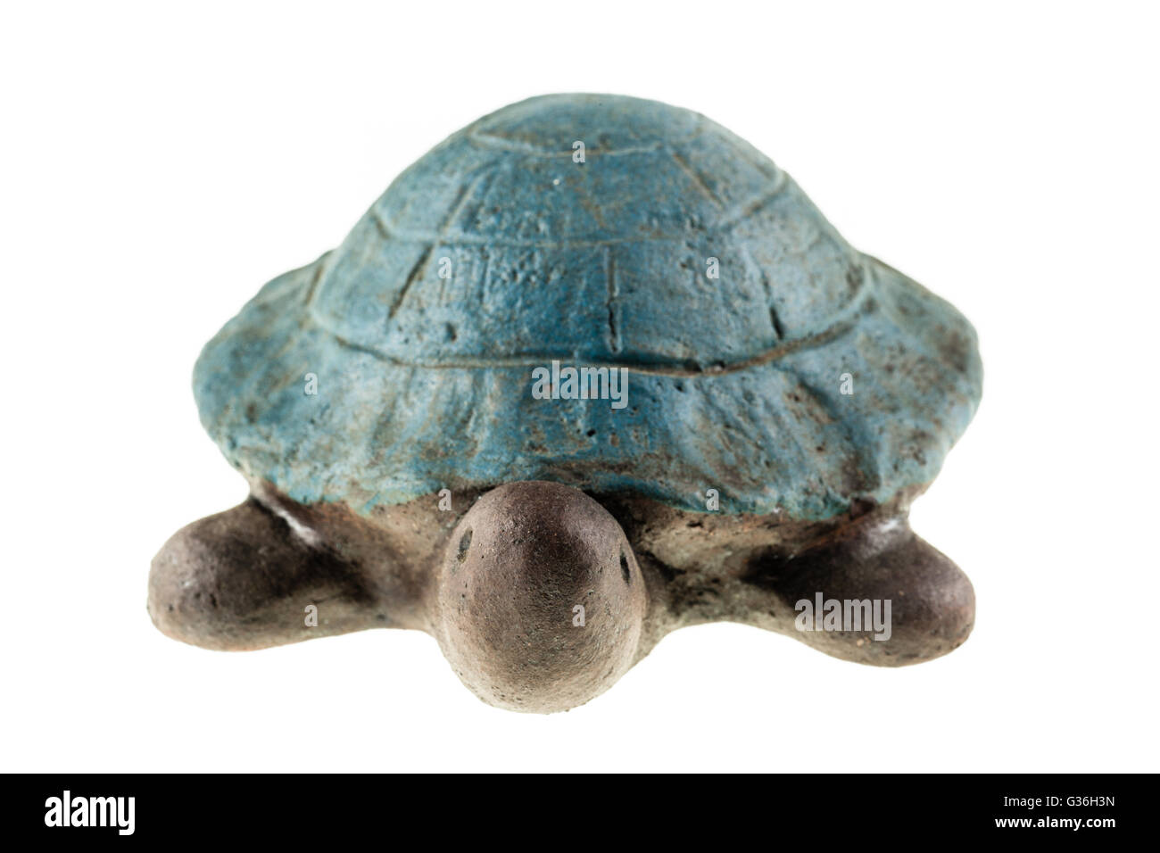 a small clay turtle figurine isolated over a white background Stock Photo