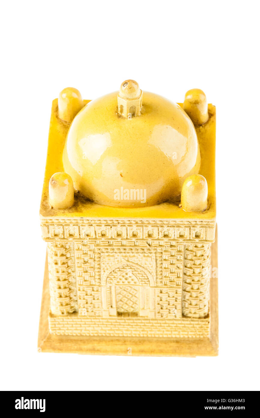 a yellow ceramic small mosque model isolated over a white background Stock Photo