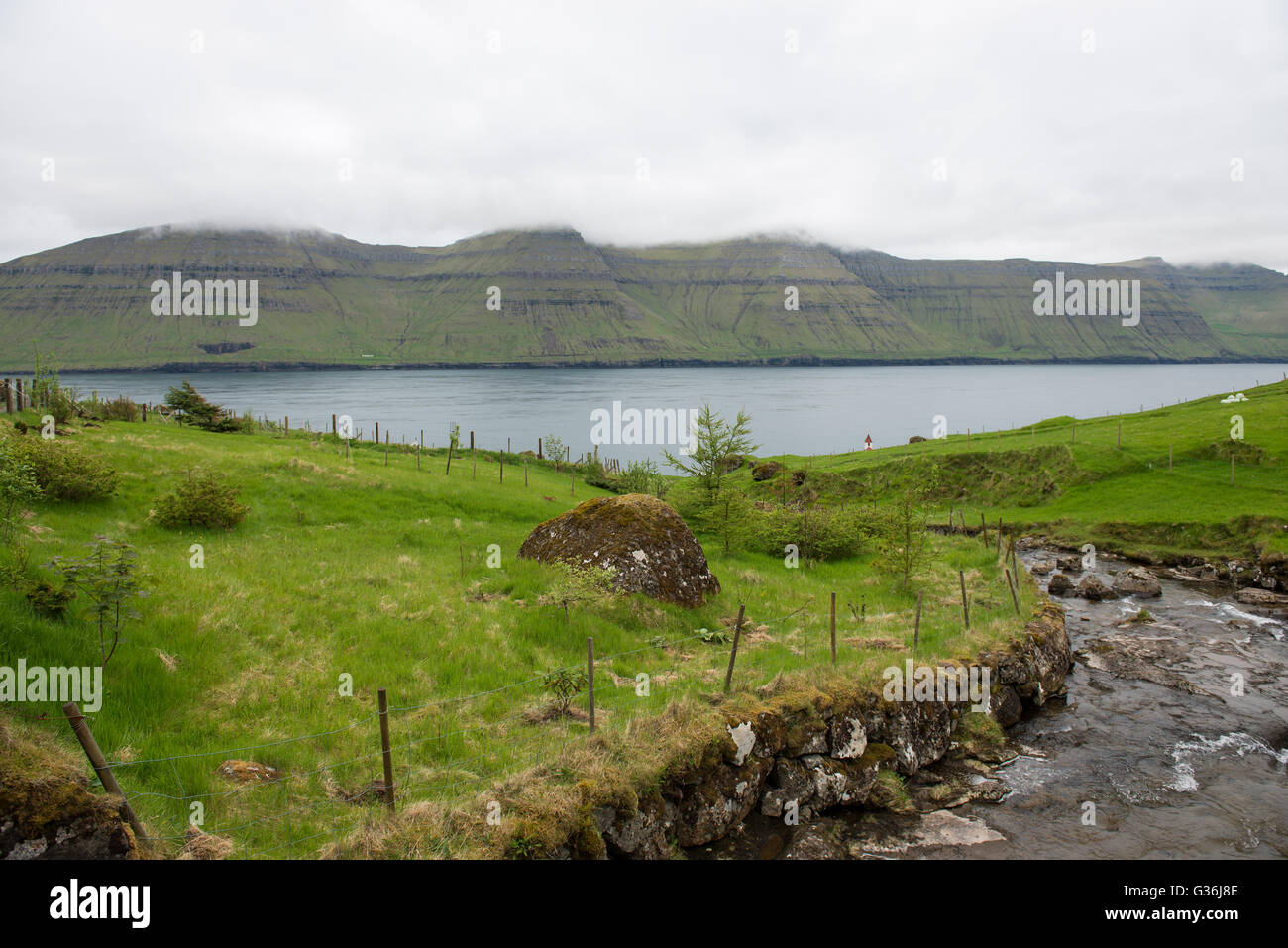 River on Kunoy and view towards Kalsoy on the Faroe Islands Stock Photo
