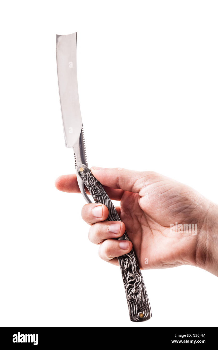 a male hand holding a big cut throat straight razor isolated over a white background Stock Photo