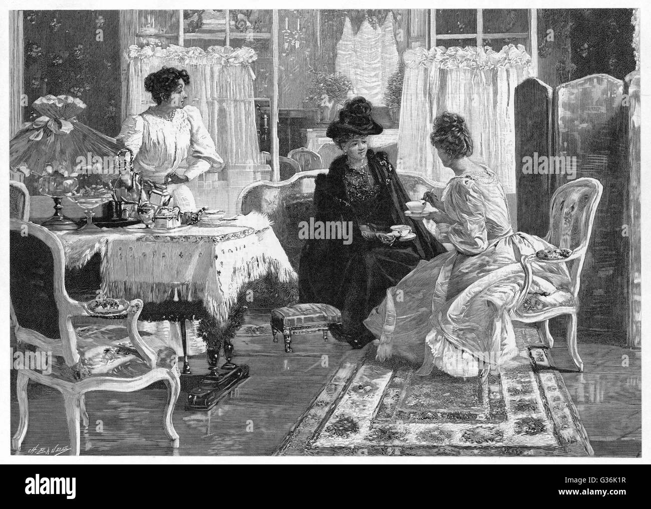 A lady entertains a  visitor to afternoon tea in a lush interior.  The maid stands ready to pour more tea or offer a plate of  food.         Date: 1892 Stock Photo