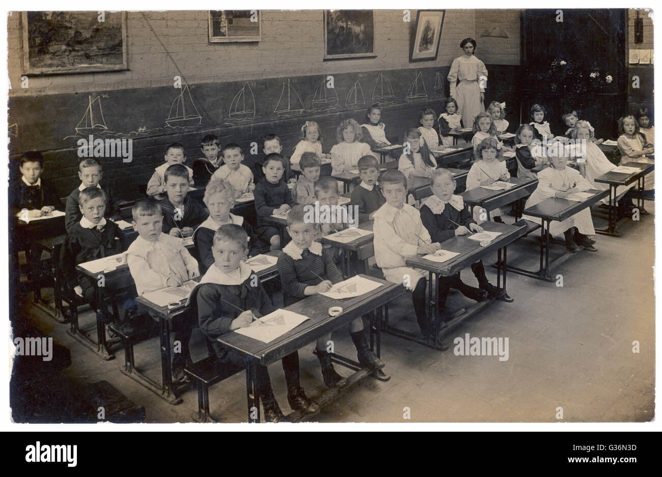 A drawing class in a North London primary school -- boys on one side, girls on the other.       Date: circa 1905 Stock Photo
