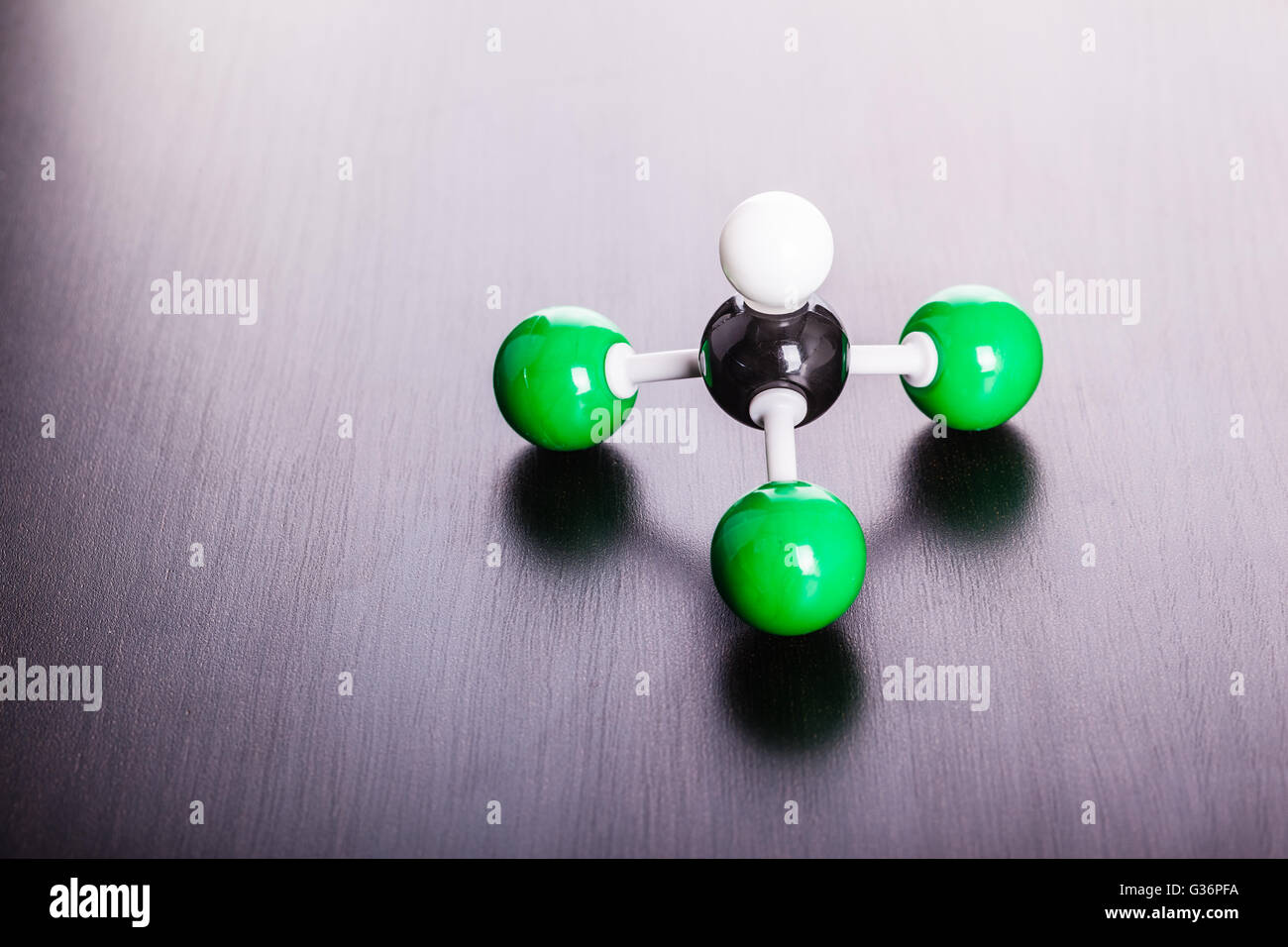 a chloroform molecule plastic chemical structure model on a wooden surface Stock Photo