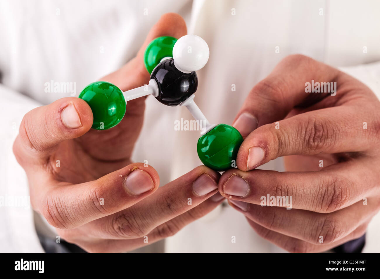 a young researcher in lab coat holding the chloroform molecular structure model Stock Photo