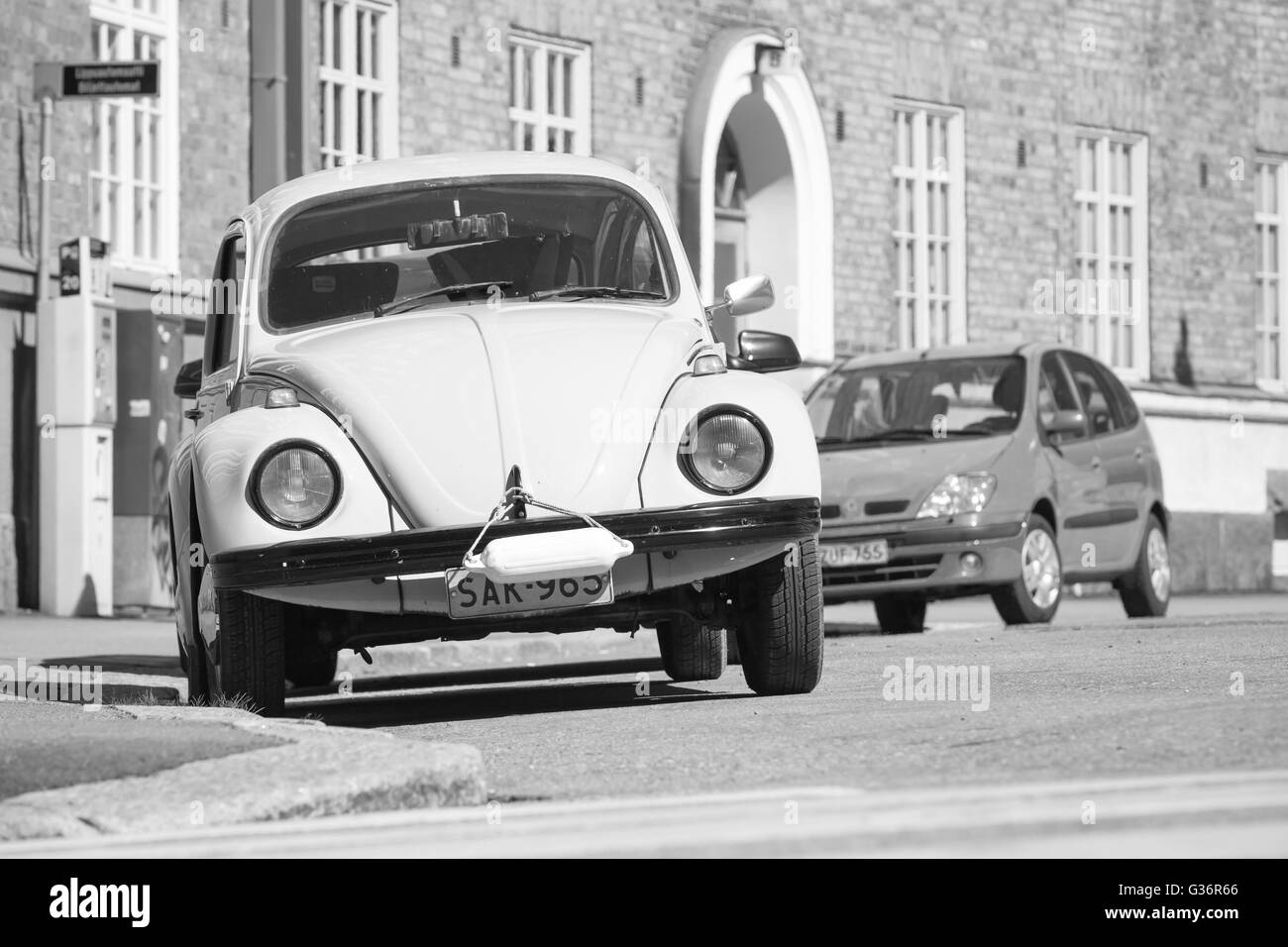 Helsinki, Finland - May 7, 2016: Old Volkswagen beetle is parked on a roadside, front view, black and white photo Stock Photo