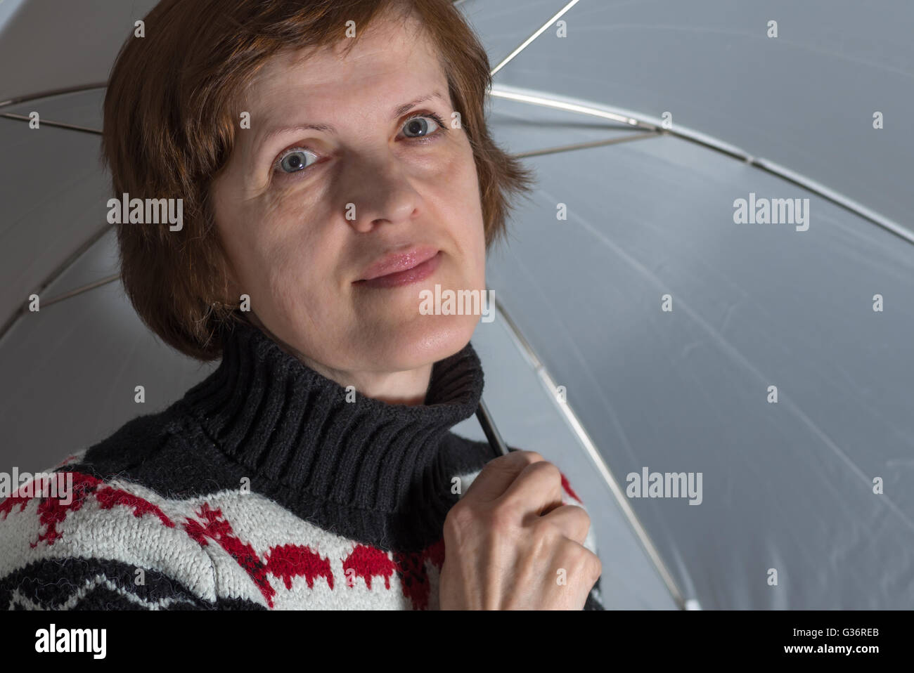 Portrait of ordinary Slavic woman under white umbrella Stock Photo