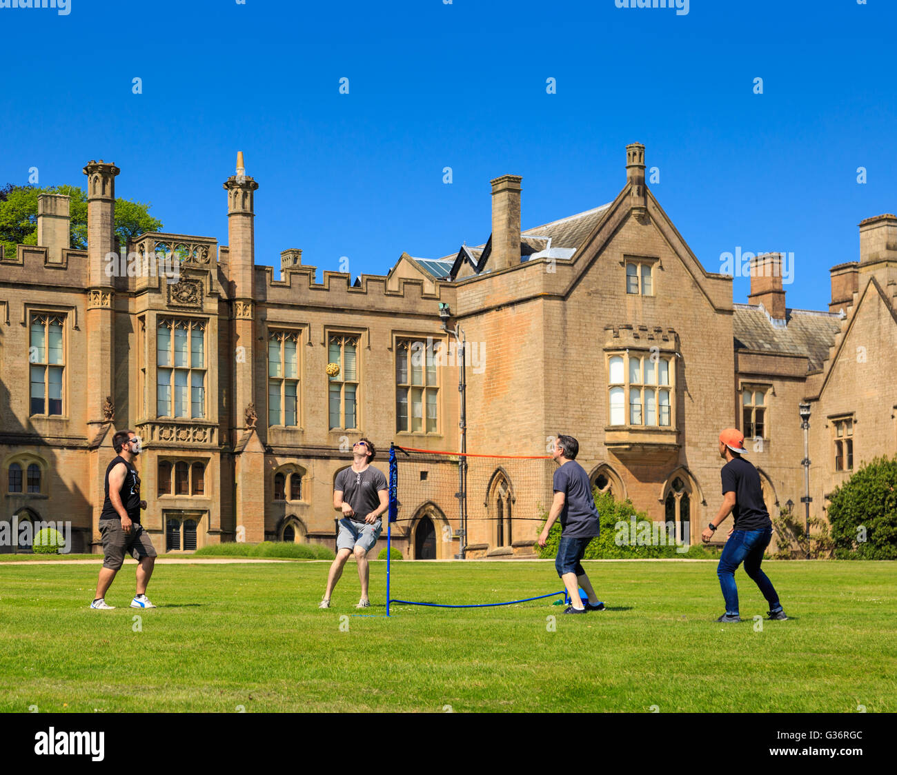 A group of young men playing Sepak Takraw (kick volleyball) on the lawn. At Newstead Abbey Stock Photo