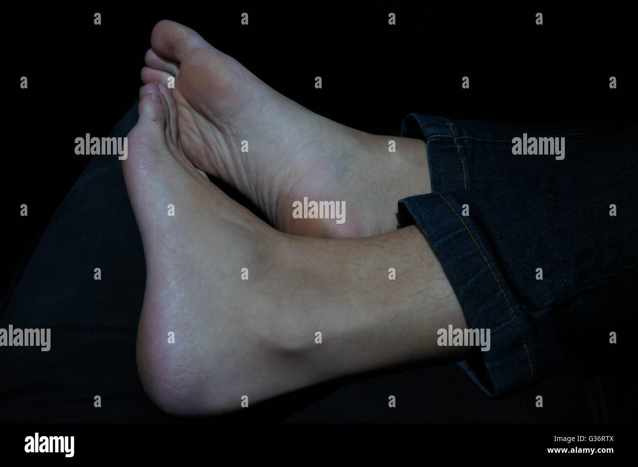 A pair of feet on a couch Stock Photo Alamy