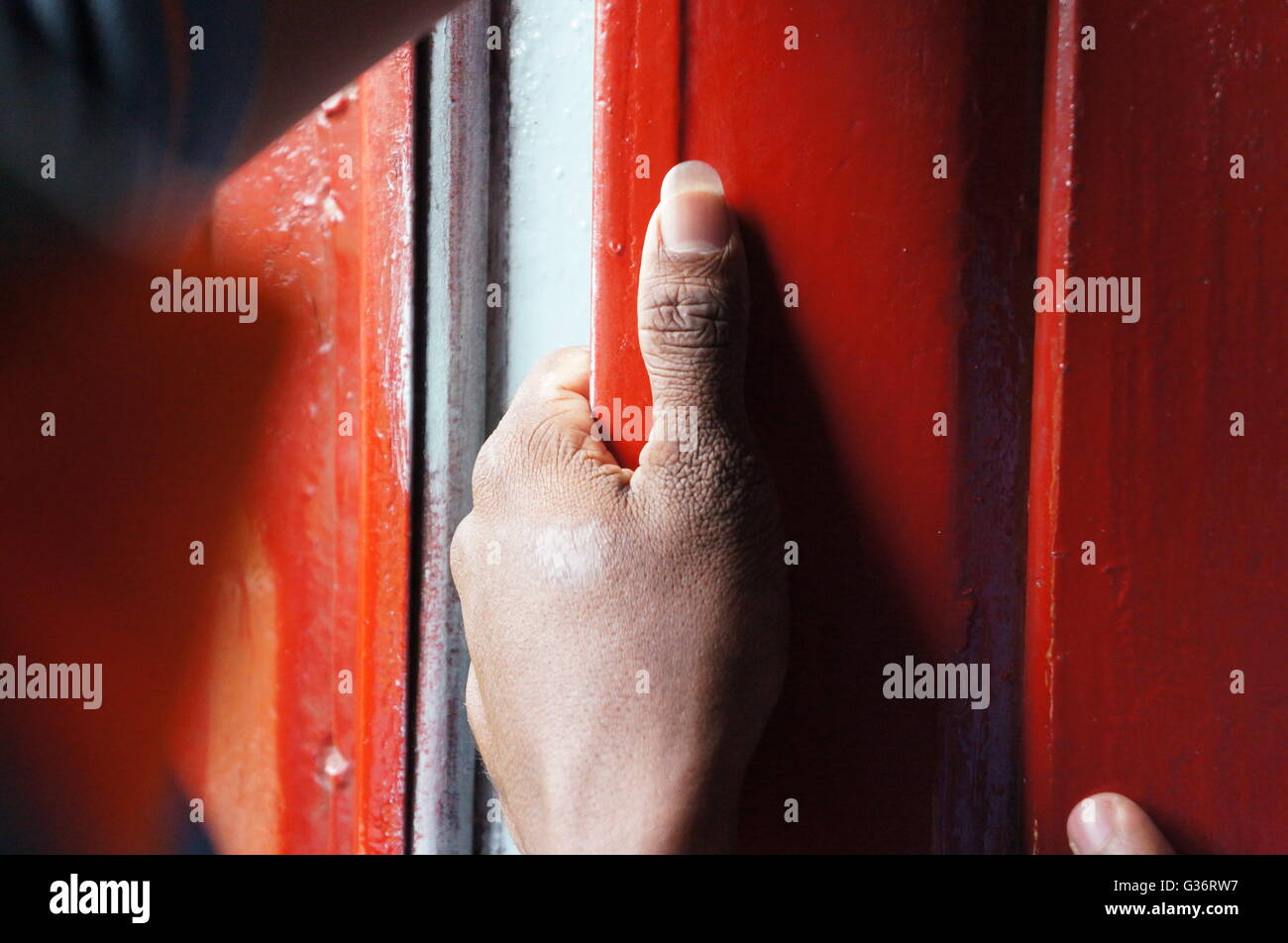 The hand of a man in a train from Colombo to Kandy, Sri Lanka Stock Photo