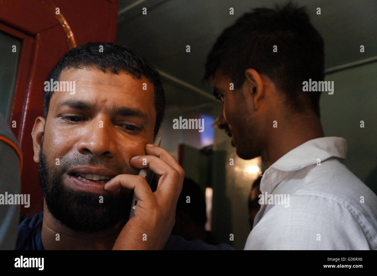 A man is making a phone call in a crowded train from Colombo to Kandy, Sri Lanka. Stock Photo