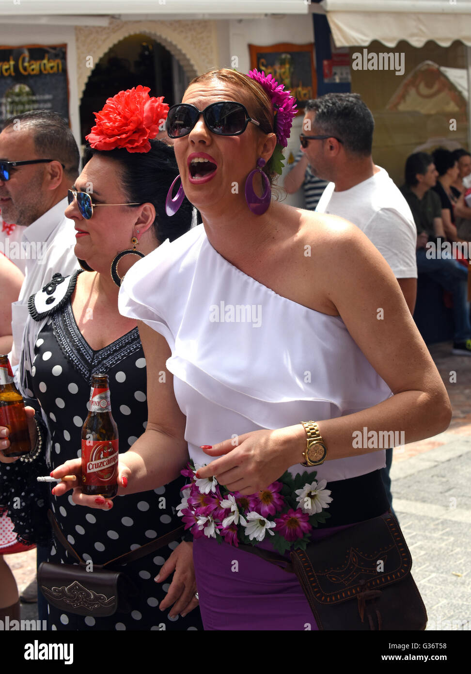 woman smoking and drinking at San Isidro festival fiesta in Nerja Andalucia Spain Stock Photo