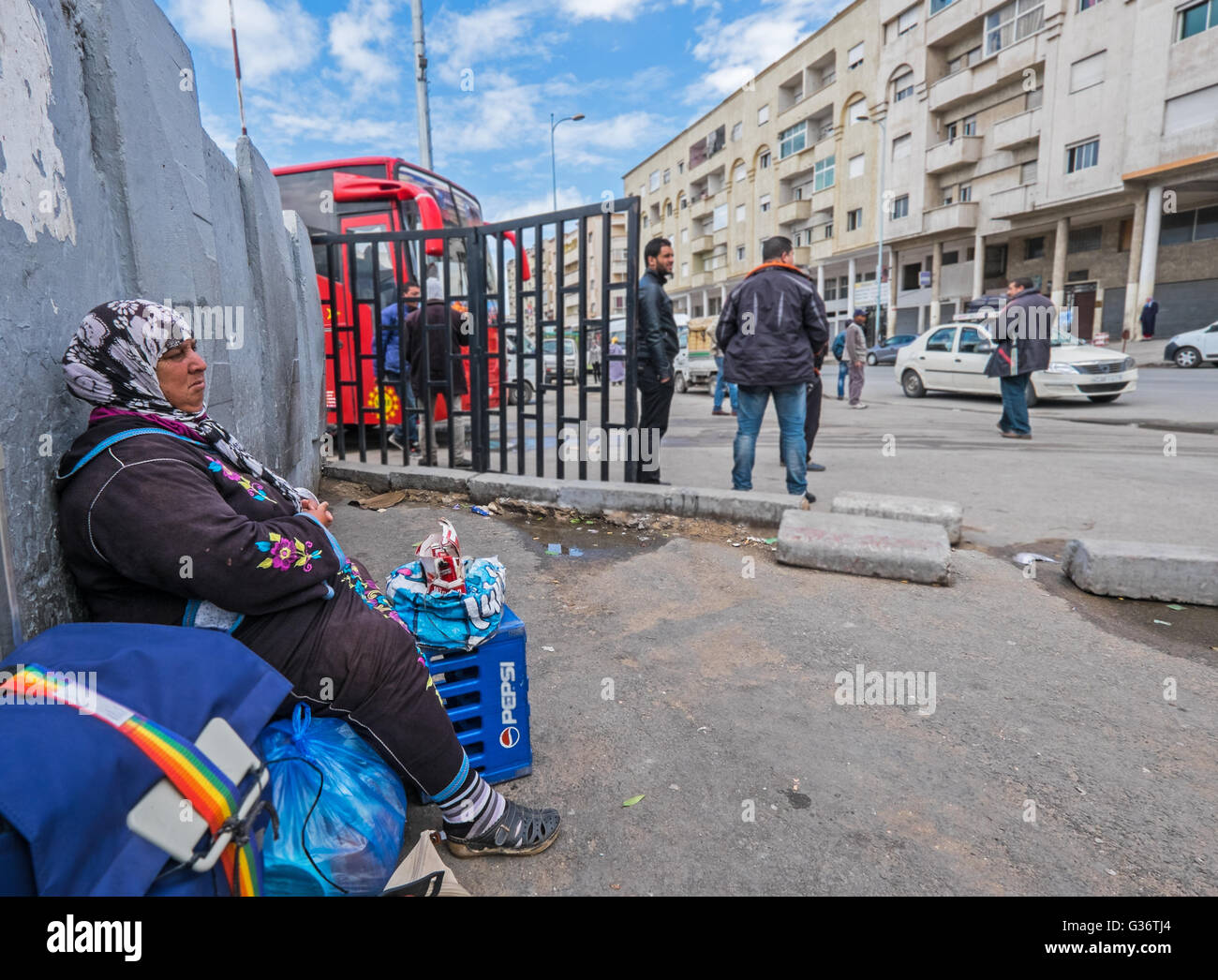 an elderly female cigarette vendor on the street of a Moroccan town Stock  Photo