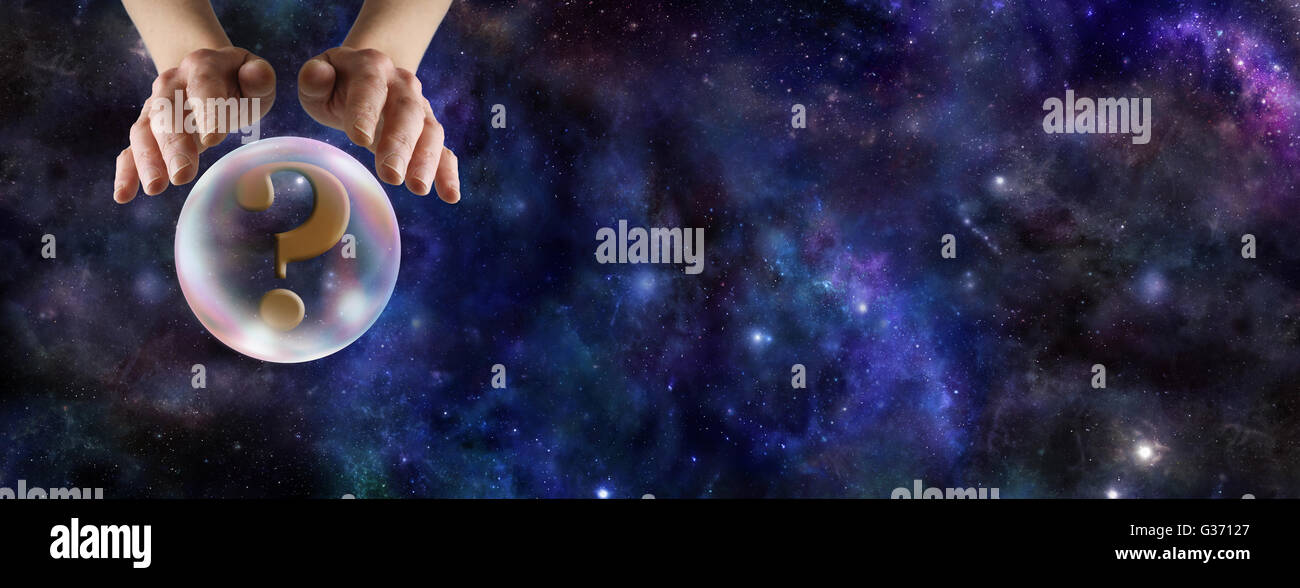 Wide deep space background with a fortune teller's hands hovering over a crystal ball containing a question mark with copy space Stock Photo