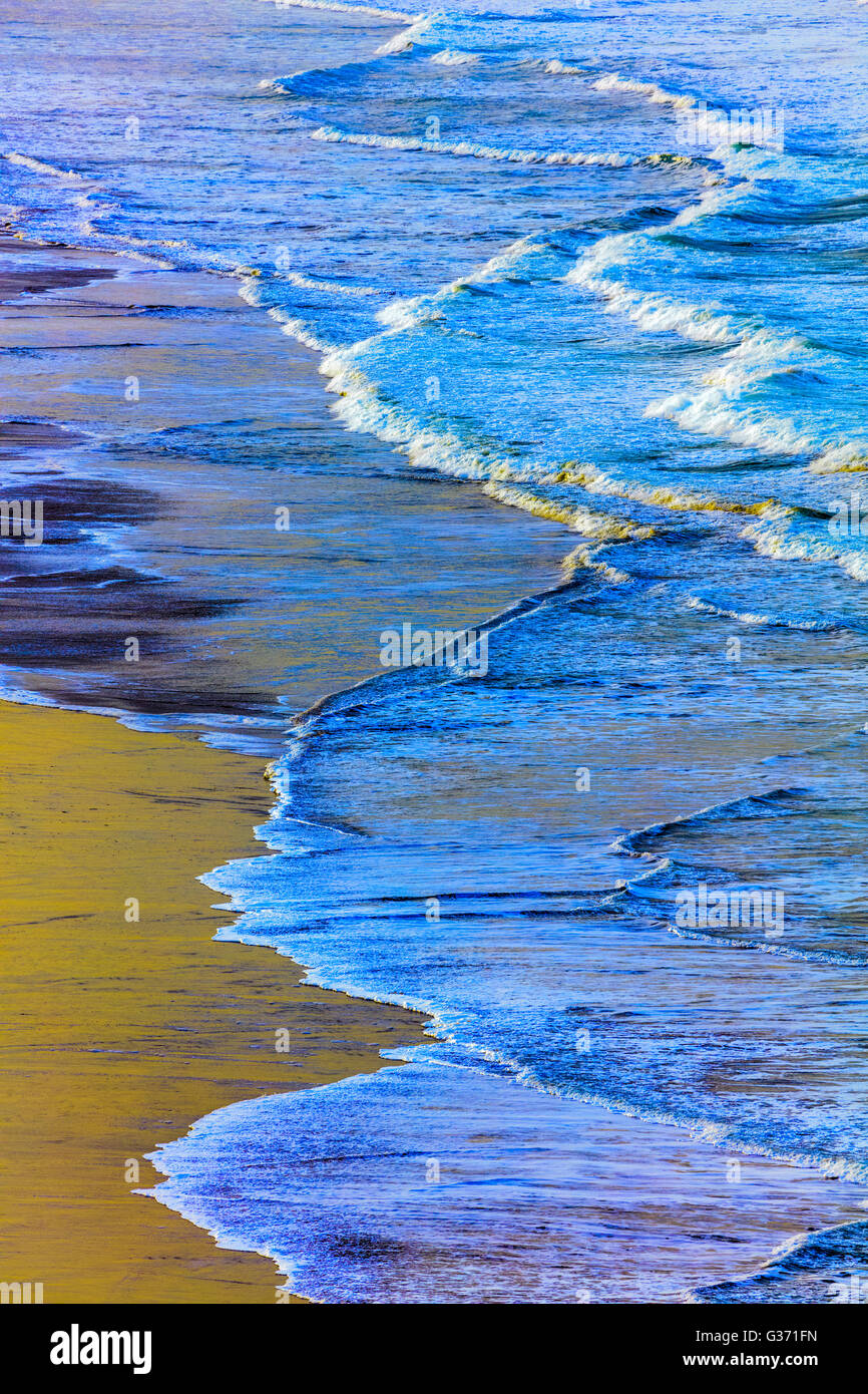 Surf rolling onto expansive sand beach on the Oregon Coast Stock Photo