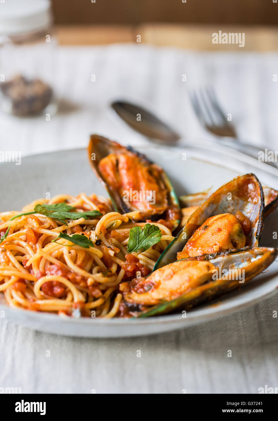Spaghetti with Mussel in tomato and herbs sauce Stock Photo