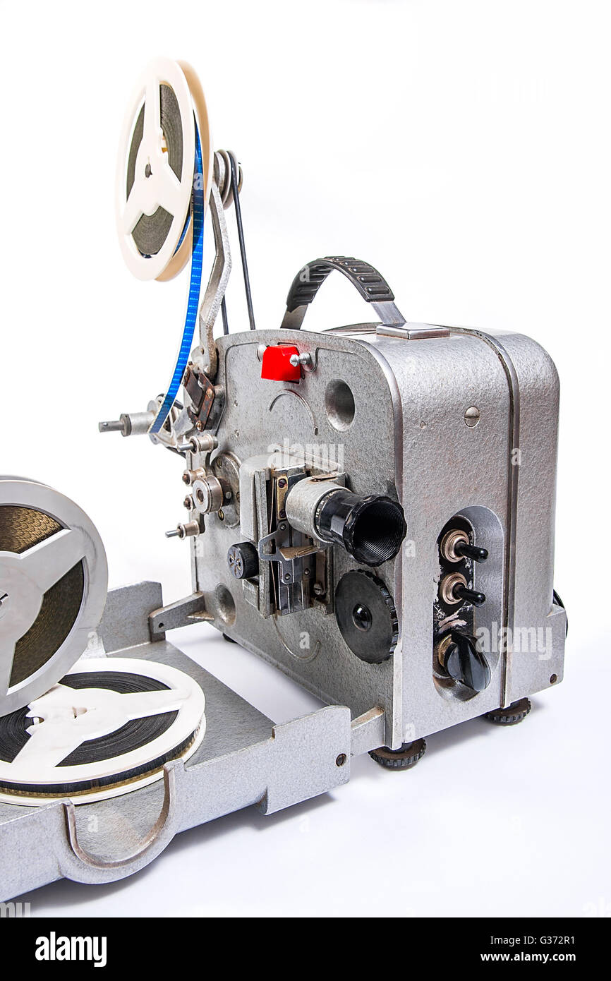 Retro old reel movie projector for cinema. A reels of motion picture film on a white background. Analogue movie projector Stock Photo
