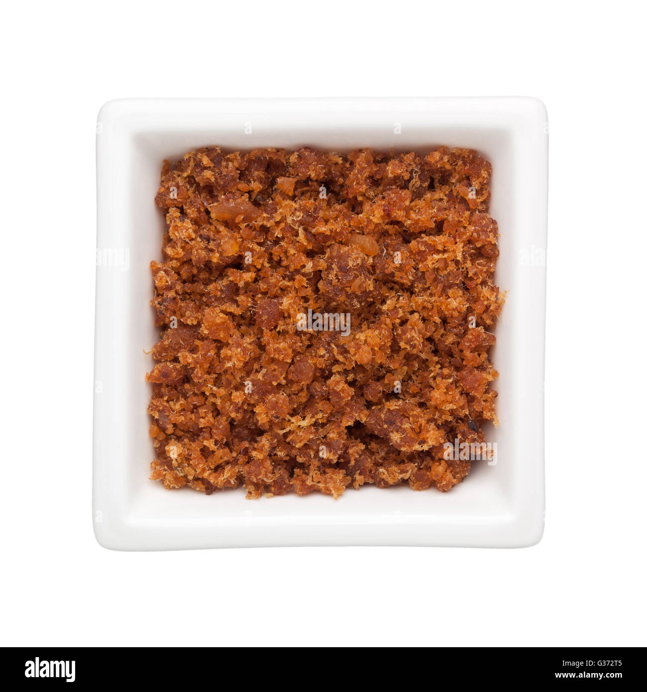 Spicy dried shrimp sambal in a square bowl isolated on white background