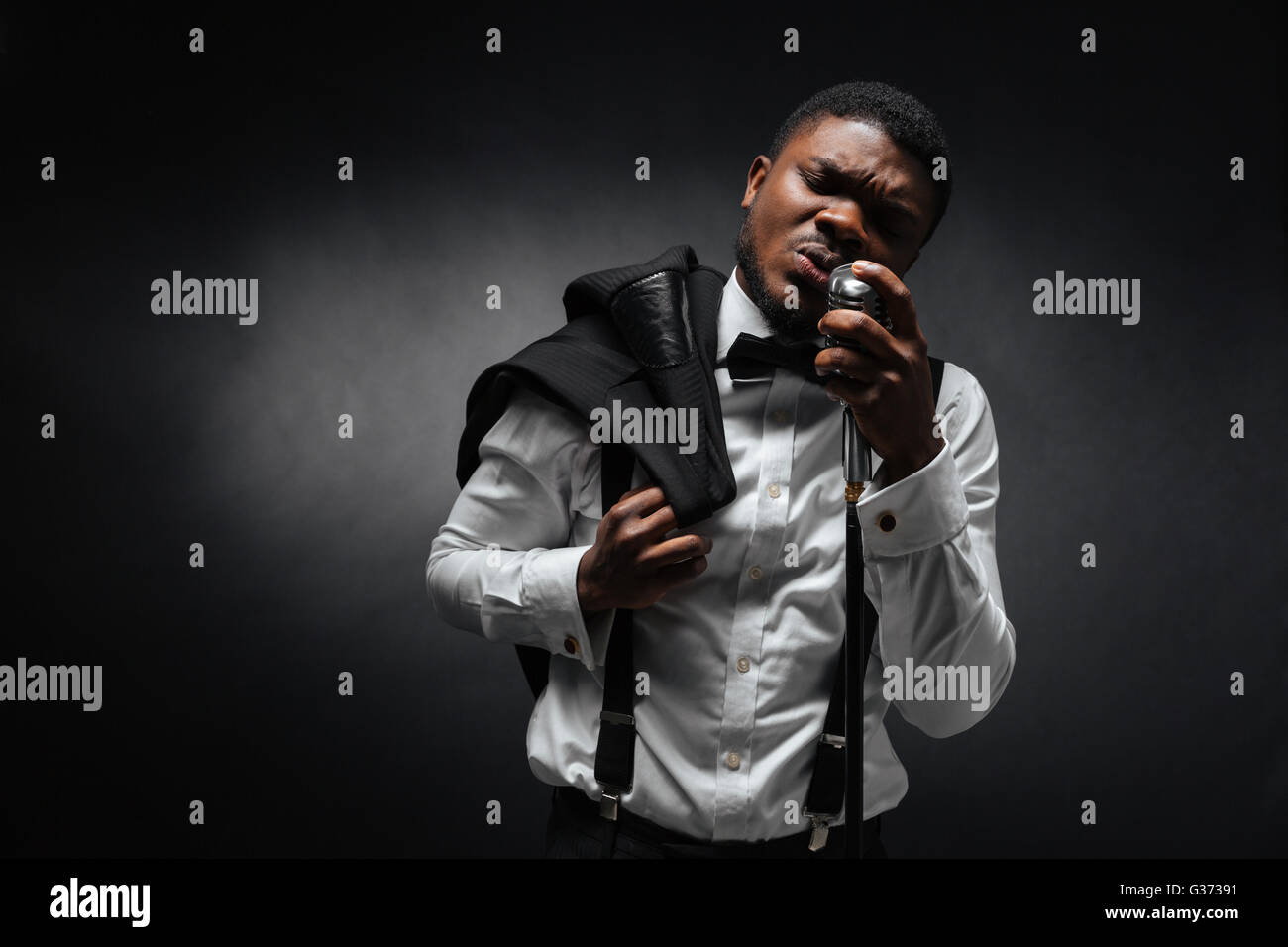 Singing man black suit microphone hi-res stock photography and images ...