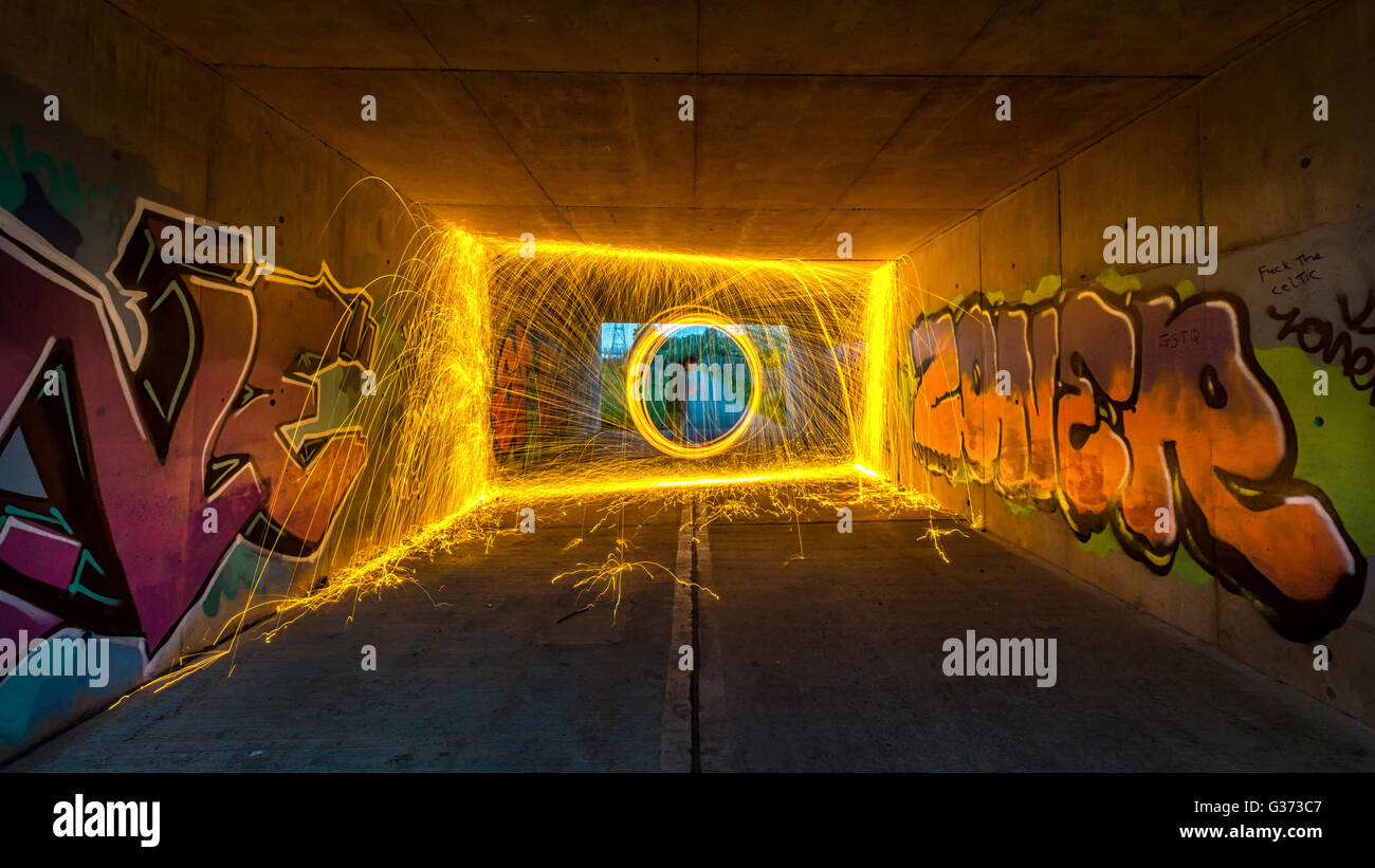Wire Wool Spinning in a graffiti tunnel Stock Photo