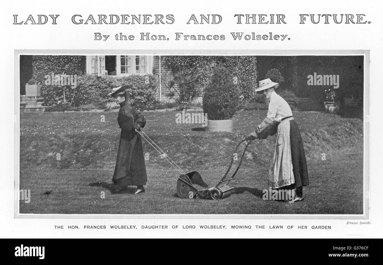 The Honorable Frances Wolseley  mowing the lawn of her garden  assisted by a friend pulling  the lawnmower along by a cord       Date: 1906 Stock Photo