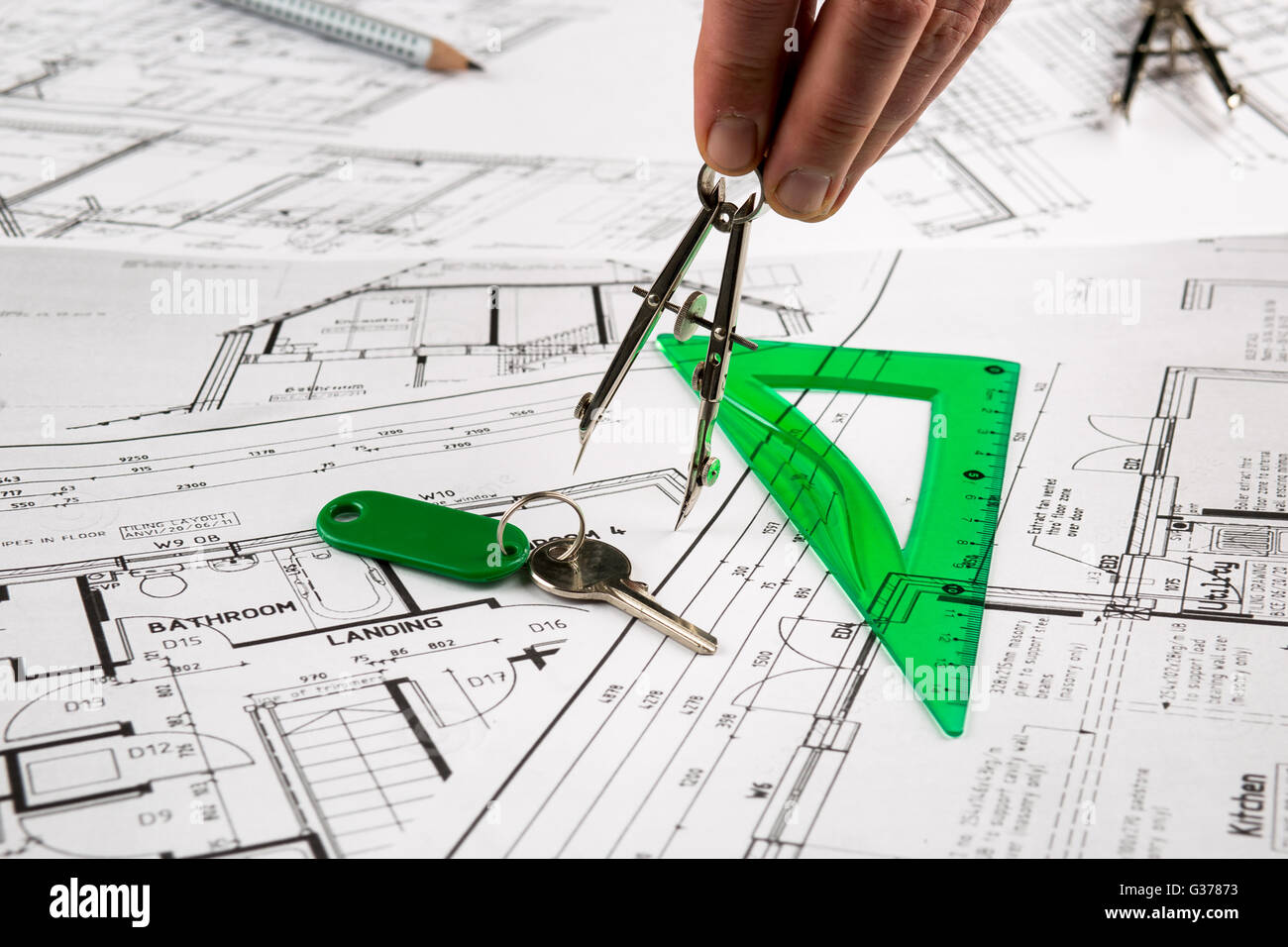 Architect plans construction project drawing, the cost of building a house Stock Photo Alamy
