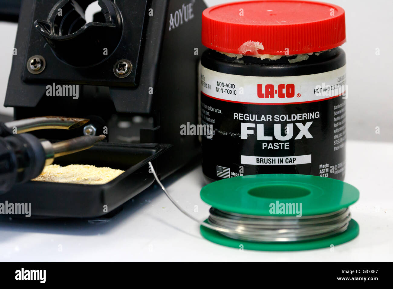 Tub of flux and spool of solder next to soldering iron Stock Photo Alamy