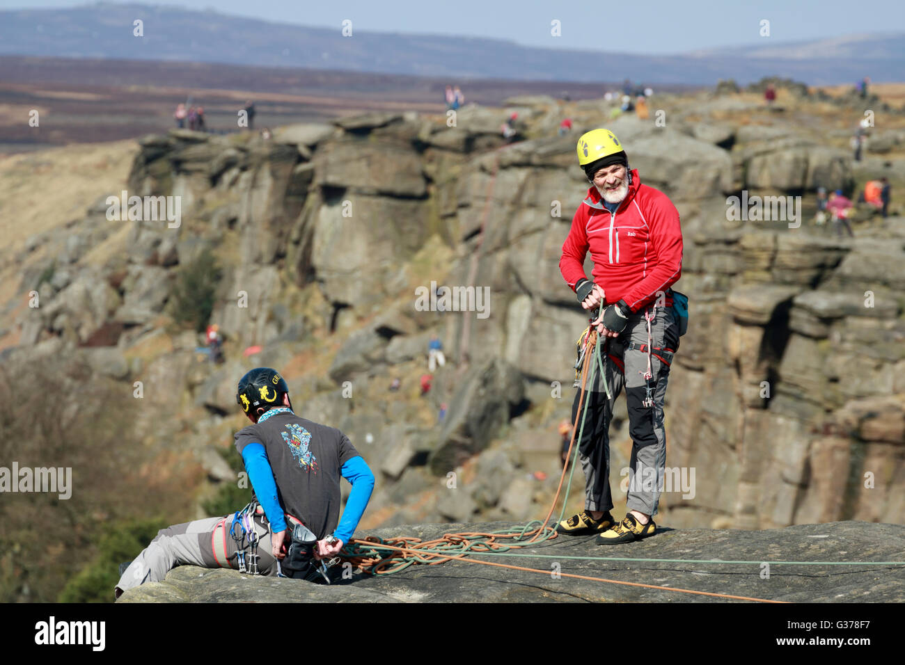 Rock climbers with ropes and safety gear in the Peak District
