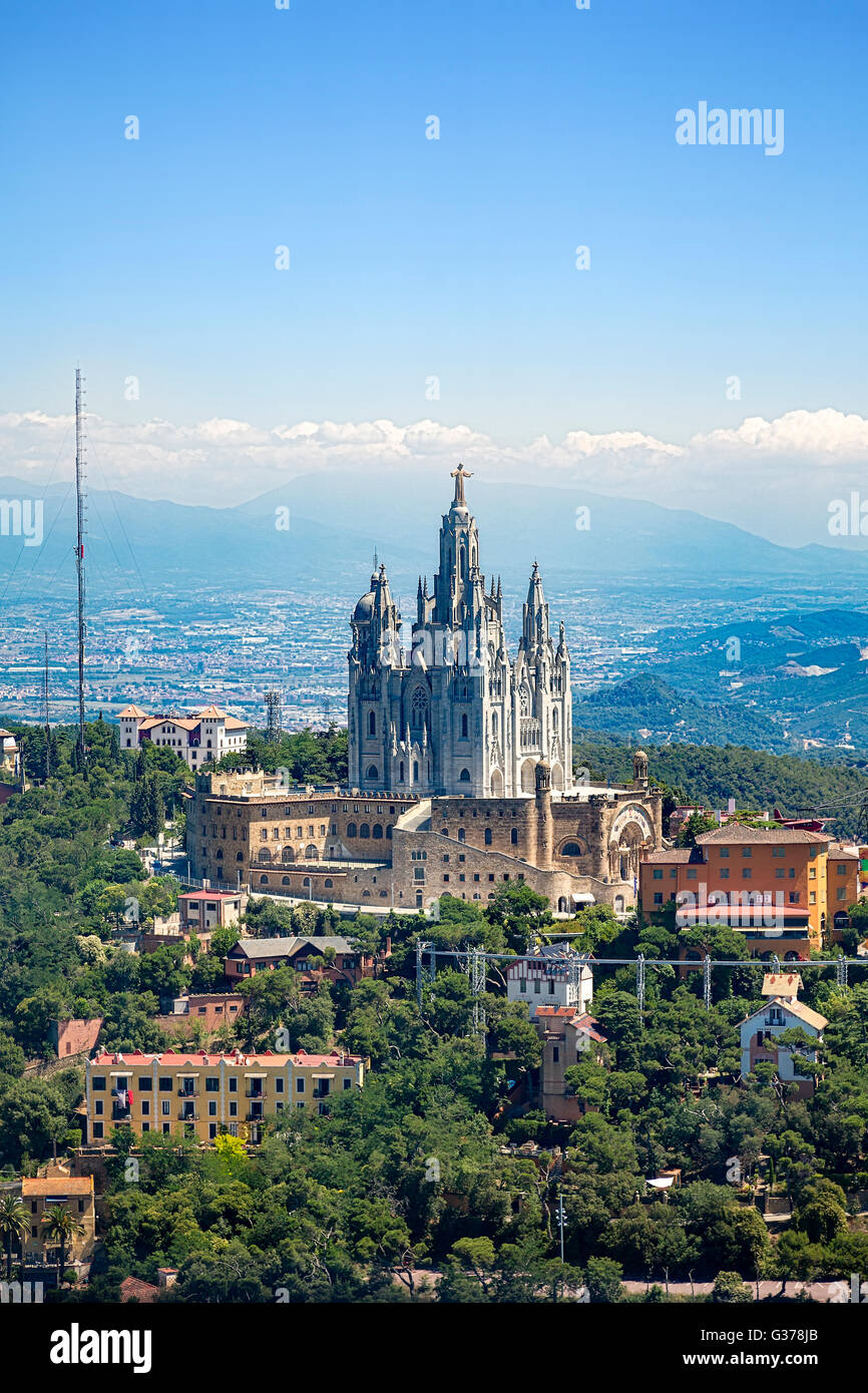 Tibidabo church on mountain in Barcelona with christ statue overviewing the city Stock Photo