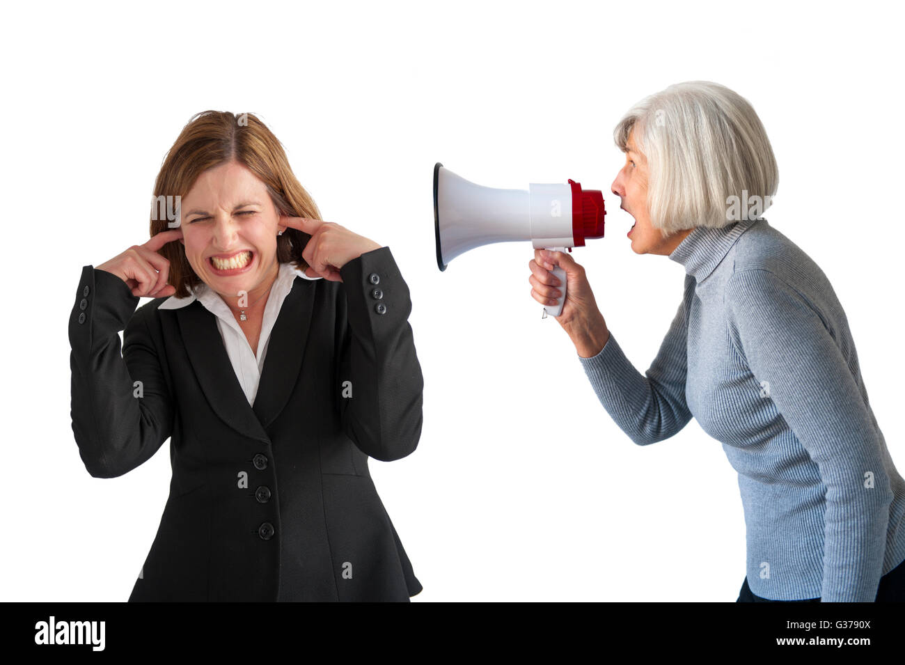 mature woman being shouted at by senior woman on white Stock Photo
