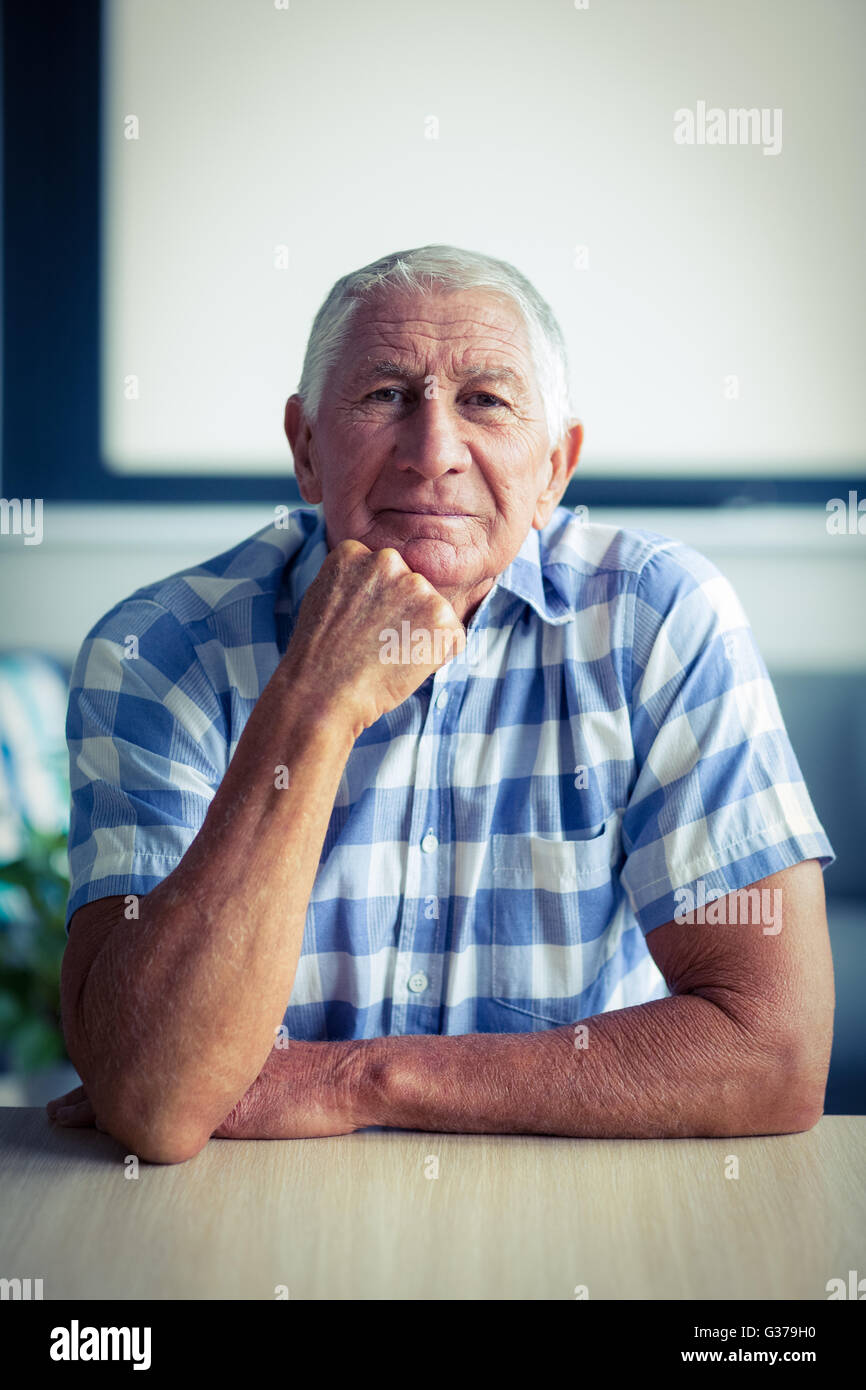 Portrait of senior man sitting hi-res stock photography and images - Alamy